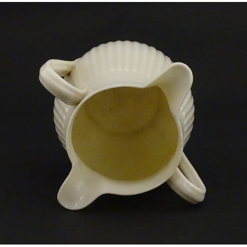 70 - A Belleek Lifford pattern double spout cream jug with twin handles. Marked with Second Period mark u... 