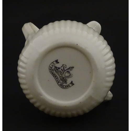 70 - A Belleek Lifford pattern double spout cream jug with twin handles. Marked with Second Period mark u... 
