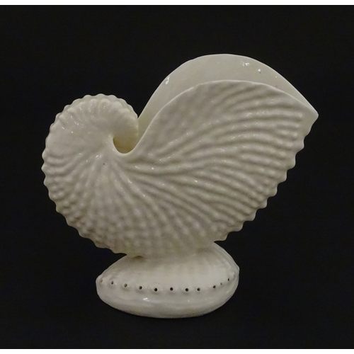 71 - A Belleek Nautilus shell spill vase. Marked with Second Period mark under. Approx. 4
