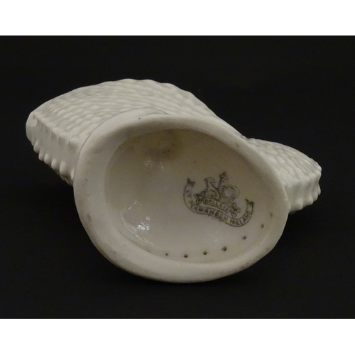 71 - A Belleek Nautilus shell spill vase. Marked with Second Period mark under. Approx. 4