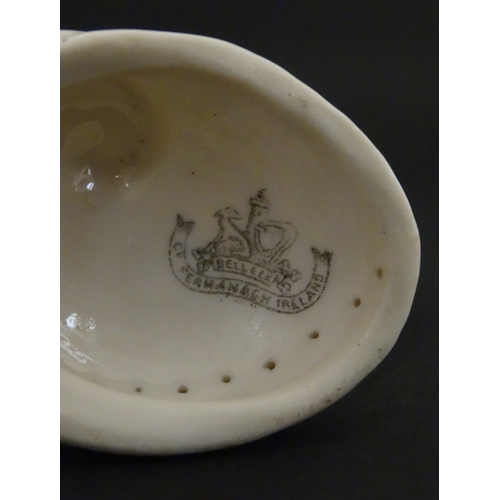 71 - A Belleek Nautilus shell spill vase. Marked with Second Period mark under. Approx. 4