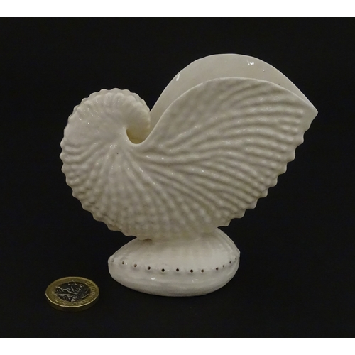 71 - A Belleek Nautilus shell spill vase. Marked with Second Period mark under. Approx. 4
