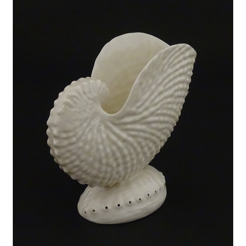 71 - A Belleek Nautilus shell spill vase. Marked with Second Period mark under. Approx. 4