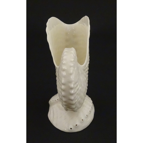 71 - A Belleek Nautilus shell spill vase. Marked with Second Period mark under. Approx. 4