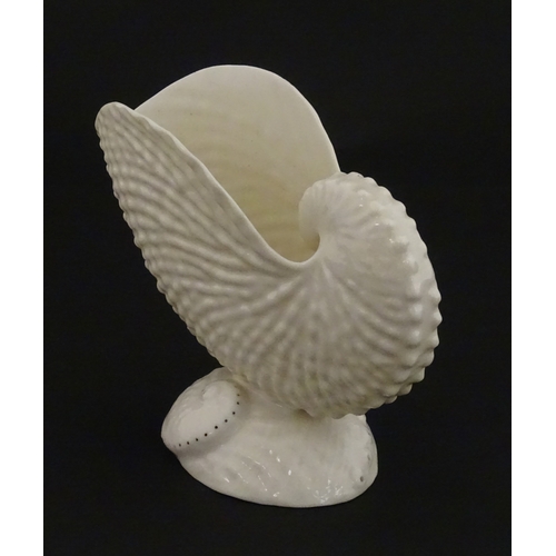 71 - A Belleek Nautilus shell spill vase. Marked with Second Period mark under. Approx. 4