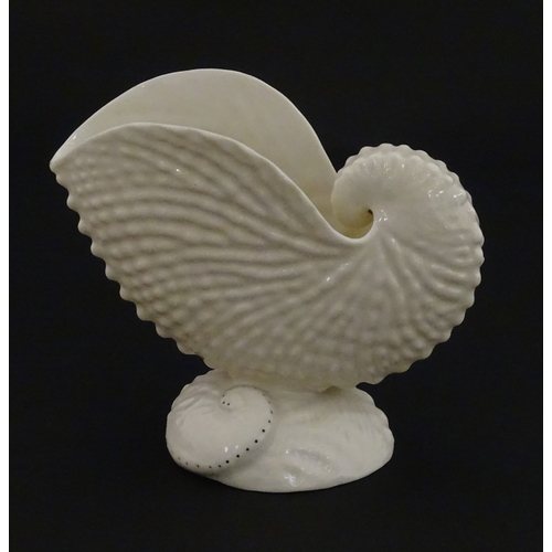 71 - A Belleek Nautilus shell spill vase. Marked with Second Period mark under. Approx. 4