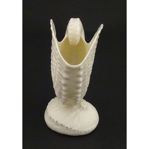 71 - A Belleek Nautilus shell spill vase. Marked with Second Period mark under. Approx. 4