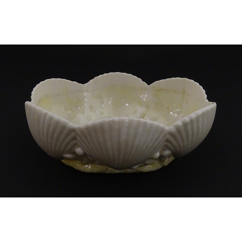 73 - A Belleek dish with shell decoration and lustre highlights. Marked with First Period mark under. App... 
