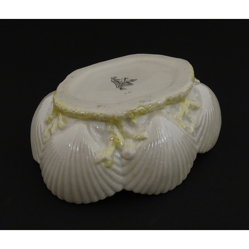 73 - A Belleek dish with shell decoration and lustre highlights. Marked with First Period mark under. App... 
