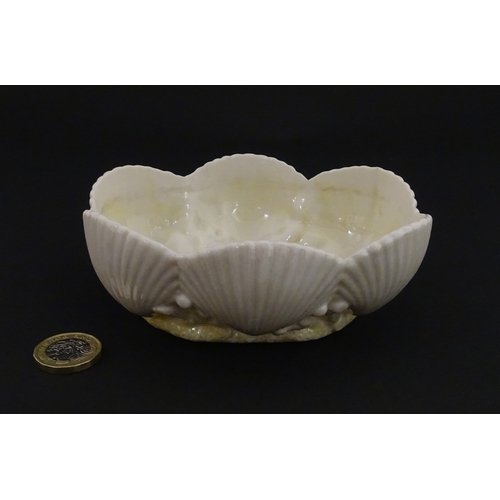 73 - A Belleek dish with shell decoration and lustre highlights. Marked with First Period mark under. App... 