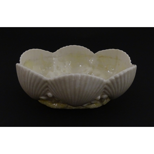 73 - A Belleek dish with shell decoration and lustre highlights. Marked with First Period mark under. App... 