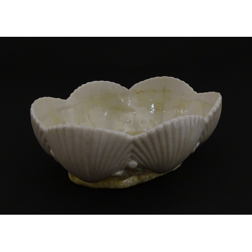 73 - A Belleek dish with shell decoration and lustre highlights. Marked with First Period mark under. App... 