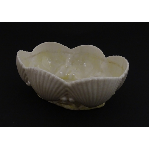 73 - A Belleek dish with shell decoration and lustre highlights. Marked with First Period mark under. App... 