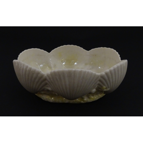 73 - A Belleek dish with shell decoration and lustre highlights. Marked with First Period mark under. App... 