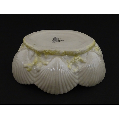 73 - A Belleek dish with shell decoration and lustre highlights. Marked with First Period mark under. App... 