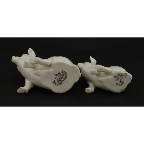 74 - Two Belleek models of seated pigs. Both marked with Second Period mark under. Largest approx. 3