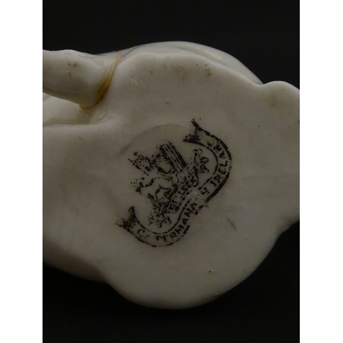 74 - Two Belleek models of seated pigs. Both marked with Second Period mark under. Largest approx. 3