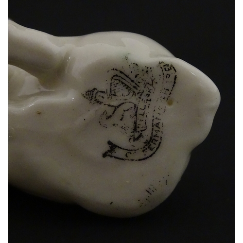 74 - Two Belleek models of seated pigs. Both marked with Second Period mark under. Largest approx. 3