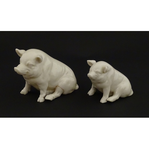 74 - Two Belleek models of seated pigs. Both marked with Second Period mark under. Largest approx. 3