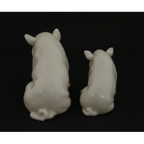 74 - Two Belleek models of seated pigs. Both marked with Second Period mark under. Largest approx. 3