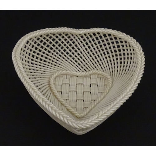 75 - A Belleek four strand basket of heart form with lattice work detail. Impressed with Second Period ma... 