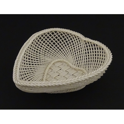 75 - A Belleek four strand basket of heart form with lattice work detail. Impressed with Second Period ma... 