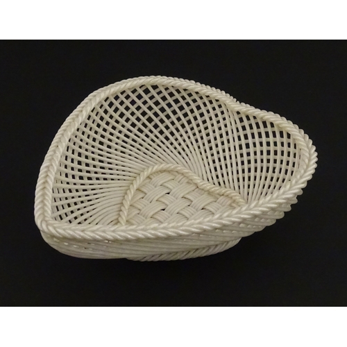 75 - A Belleek four strand basket of heart form with lattice work detail. Impressed with Second Period ma... 