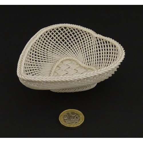 75 - A Belleek four strand basket of heart form with lattice work detail. Impressed with Second Period ma... 