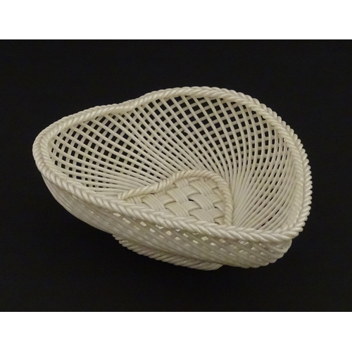75 - A Belleek four strand basket of heart form with lattice work detail. Impressed with Second Period ma... 