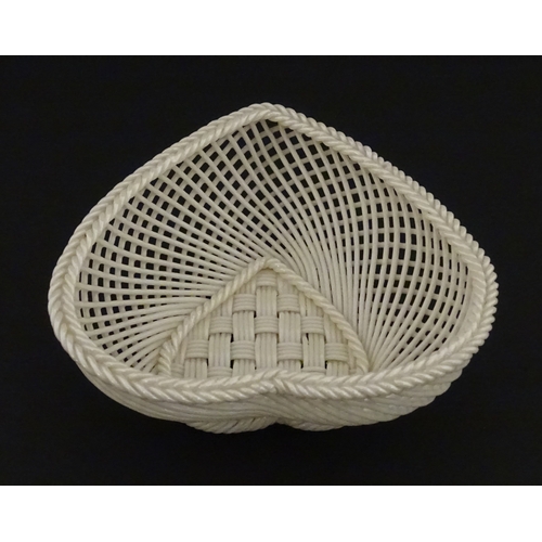 75 - A Belleek four strand basket of heart form with lattice work detail. Impressed with Second Period ma... 
