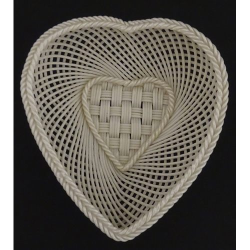 75 - A Belleek four strand basket of heart form with lattice work detail. Impressed with Second Period ma... 