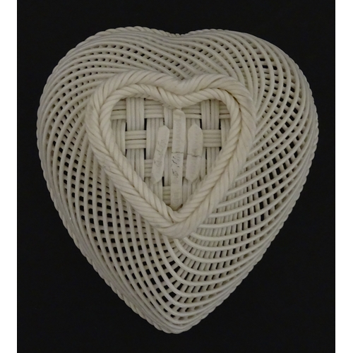 75 - A Belleek four strand basket of heart form with lattice work detail. Impressed with Second Period ma... 
