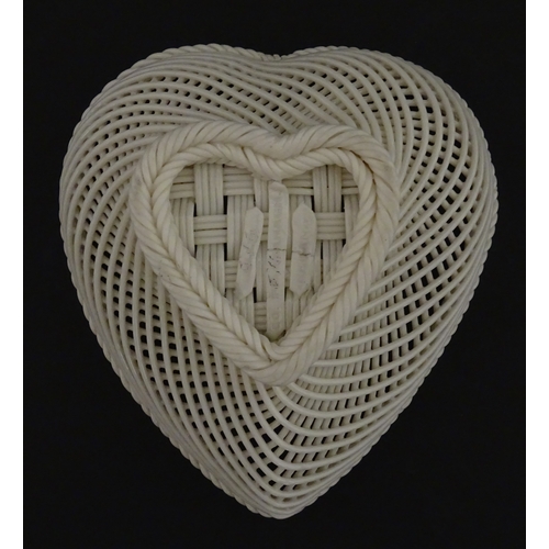 75 - A Belleek four strand basket of heart form with lattice work detail. Impressed with Second Period ma... 