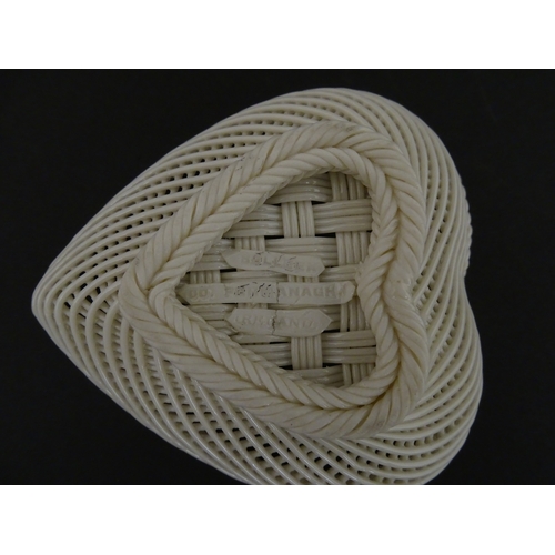 75 - A Belleek four strand basket of heart form with lattice work detail. Impressed with Second Period ma... 