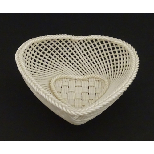 75 - A Belleek four strand basket of heart form with lattice work detail. Impressed with Second Period ma... 