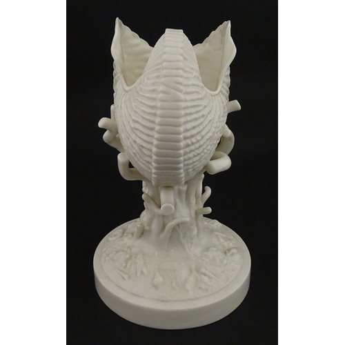 76 - A Belleek Cardium Shell on Coral centrepiece. Impressed with First Period mark under, and stamped wi... 