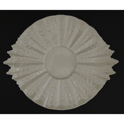77 - A Belleek Tridacna pattern cake / bread plate. Marked with Second Period mark under. Approx. 11 1/2