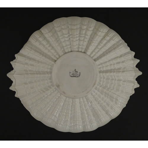 77 - A Belleek Tridacna pattern cake / bread plate. Marked with Second Period mark under. Approx. 11 1/2