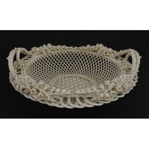 78 - A Belleek three strand Lily Basket having lattice work with ribbon edges, decorated with lily of the... 