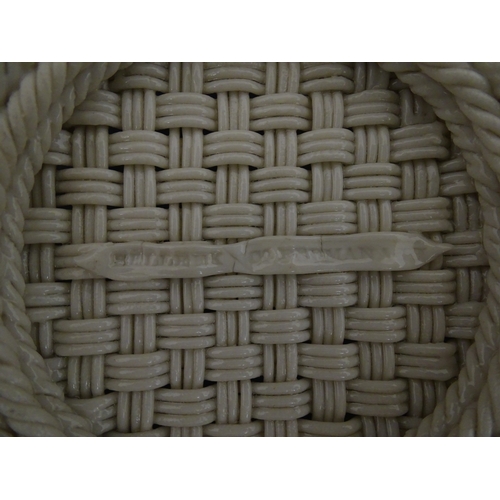 78 - A Belleek three strand Lily Basket having lattice work with ribbon edges, decorated with lily of the... 