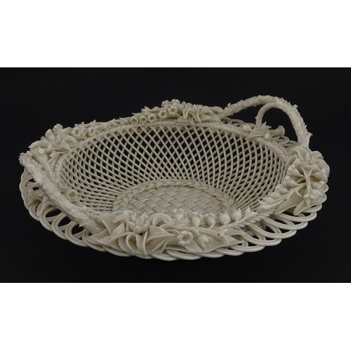 78 - A Belleek three strand Lily Basket having lattice work with ribbon edges, decorated with lily of the... 