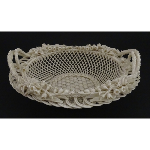 78 - A Belleek three strand Lily Basket having lattice work with ribbon edges, decorated with lily of the... 