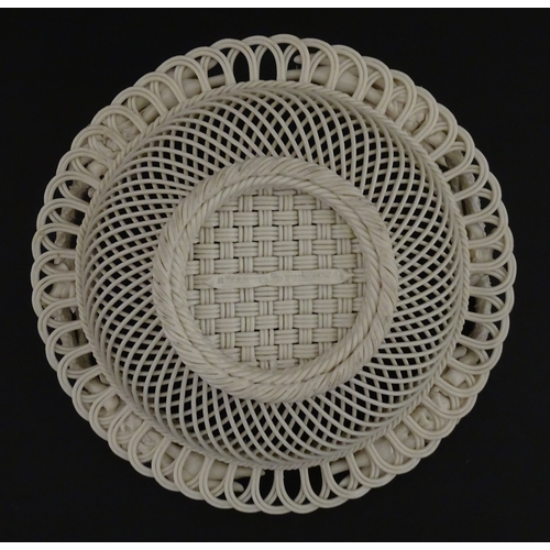 78 - A Belleek three strand Lily Basket having lattice work with ribbon edges, decorated with lily of the... 