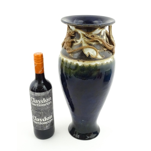 105 - A Royal Doulton vase with blue glaze and high relief dragon decoration to rim by Mark V Marshall. Ma... 