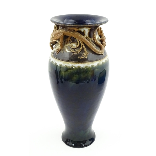 105 - A Royal Doulton vase with blue glaze and high relief dragon decoration to rim by Mark V Marshall. Ma... 