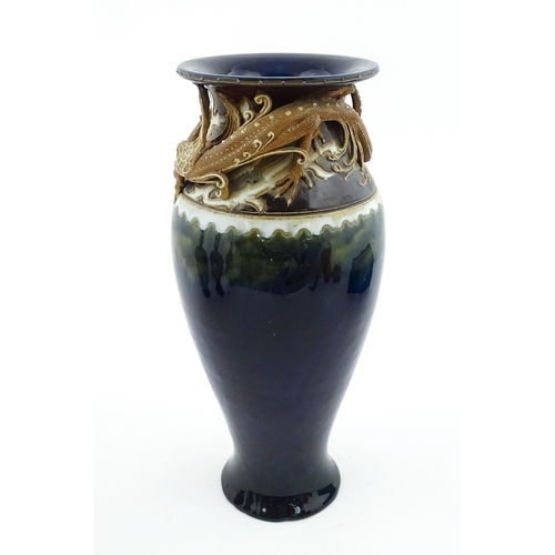 105 - A Royal Doulton vase with blue glaze and high relief dragon decoration to rim by Mark V Marshall. Ma... 