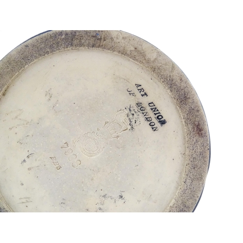 105 - A Royal Doulton vase with blue glaze and high relief dragon decoration to rim by Mark V Marshall. Ma... 