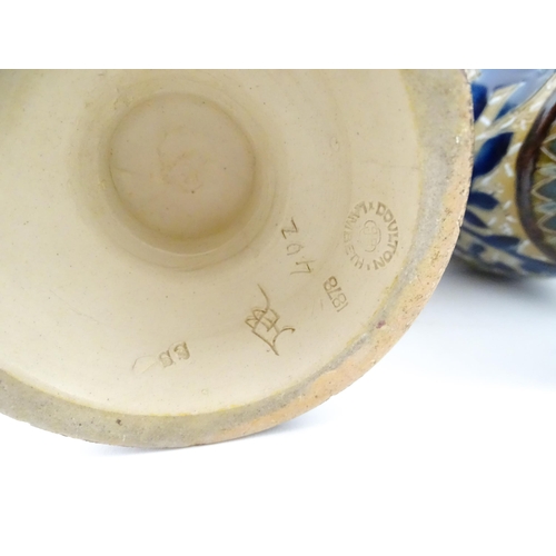107 - A pair of Doulton Lambeth stoneware vases with  floral and foliate decoration. Marked under,  bearin... 