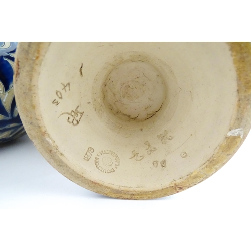 107 - A pair of Doulton Lambeth stoneware vases with  floral and foliate decoration. Marked under,  bearin... 