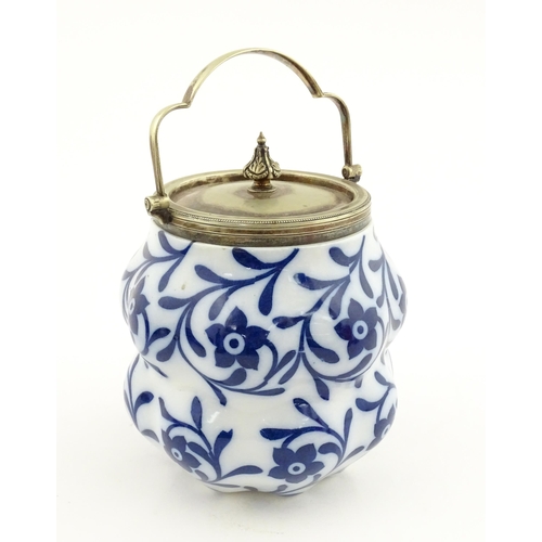 111 - A Doulton Burslem biscuit barrel of shaped form with blue and white floral and foliate decoration wi... 